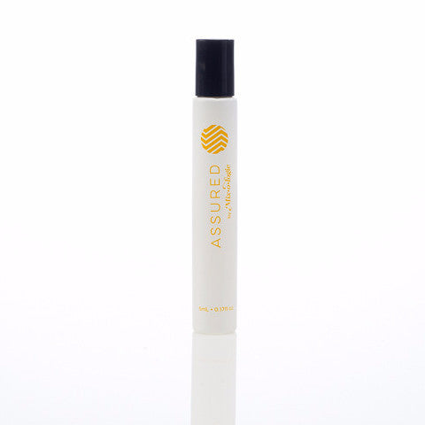 Assured (Natural) white cylinder rollerball with mustard color lettering. Rollerball has 0.17 fl oz or 5 mL. Rollerball pictured with white background.